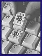 Black and white image of a keyboard with a hand lifting up a "D" key, which features tactile bumps. 