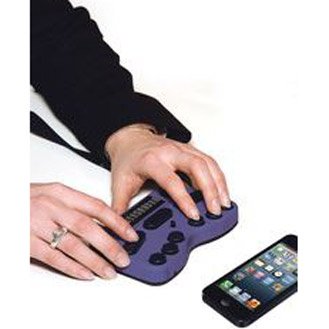 Hands operating the Braille keyboard device beneath a cell phone