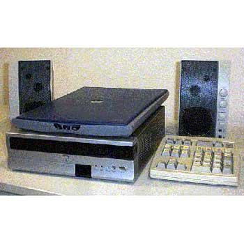 Two black speakers, a light grey flatbed scanner, a rectangular reader under the scanner, and an oversized keypad.