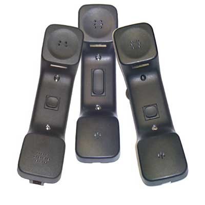Three black handsets are shown, each with a button of a different size and placement in the middle of the grip.