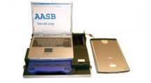 Laptop computer connected to a flatbed scanner. 
