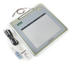 Tablet device with a stylus in a slot on the top, a coiled cable on the right, which is next to a USB drive.