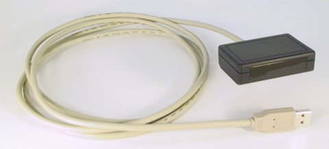 Coiled beige USB cable connected to a small back rectangular device.