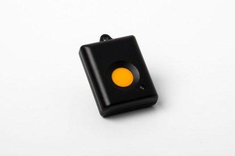 A small, black rectangular device with a yellow button in the middle.