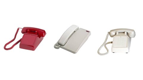 Various models of dial-less telephones, which resemble standard corded telephones, but without a number keypad or menu. Two phones are off-white, and one is red.