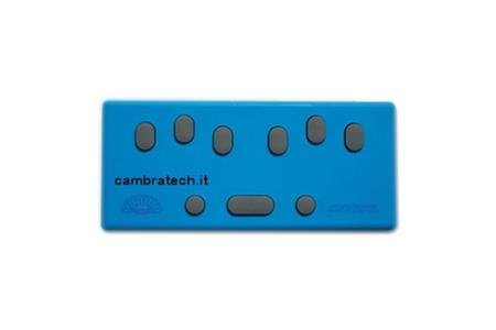 A blue rectangular device with six staggered gray oval keys on the top line and a long oblong key on the bottom line with two round keys on either side.