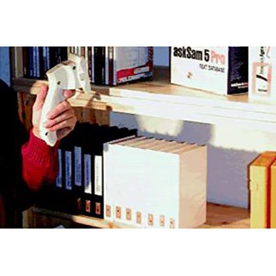 A handheld scanning device being held up to the spine of a book.