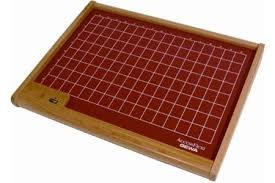 Rectangular wooden overlay tray with a mat showing 8 x 16 inch square boxes.