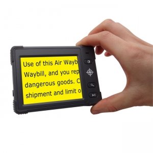 A hand holding a black video magnifier that has 4 lines of black text on a yellow background.