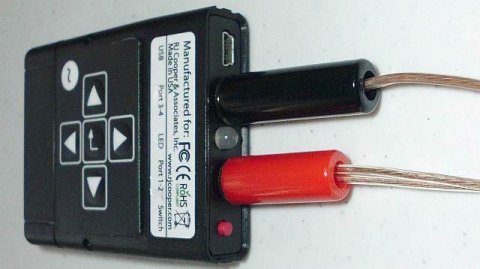 Device with directional arrows and two switches plugged into inputs.