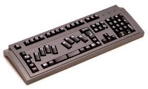 A regular black keyboard with only 8 braille keys in place of letter keys in 2 groups of 4.