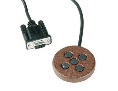 Small, round, copper-colored disc with five small buttons and a serial port connector.