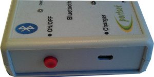 A small, rectangular device with a red power button on the side.