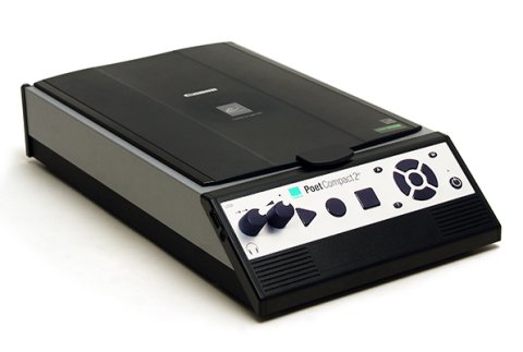 A black rectangular device with silver sides and front. Menu options on the sloped front panel are accessed via two raised dials on the left side and 3 large buttons: a triangle, circle, and a square, in the middle of the front panel. A speaker is also there on the right side of the front panel.