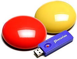 Two round flat wireless switches the size of a billiard ball with a USB drive.