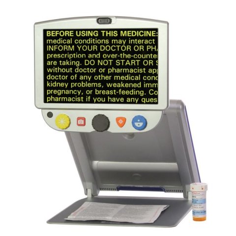 Rectangular display with a control panel attached to bottom connected to a hinged stand and tray with a pill bottle on side.