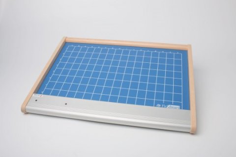 A large, thin square device with a turquoise grid.