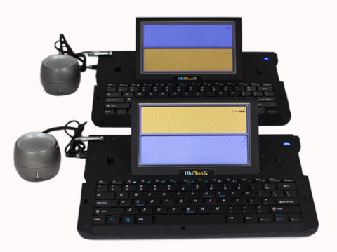 Two small, black keyboard devices, each with an LCD screen attached at the top, and a microphone attached on the lefthand side. The LCD screen is split, with a yellow half on top and a purple background at the bottom.
