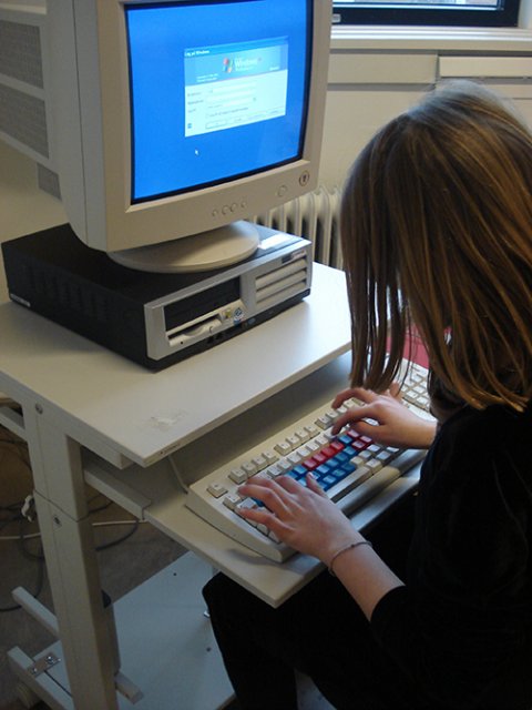 The keyboard in use by a child. 