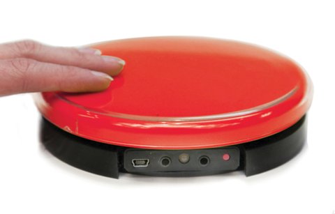 A large round red button with three inputs on the side.