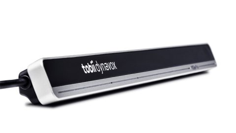 A long, thin device with a cord attached. It is silver with a black front and reads "tobii dynavox" on it.
