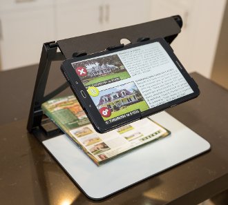 Video Magnifier with portable stand. Control buttons displayed on left side of digital screen and magnified text displayed on screen.