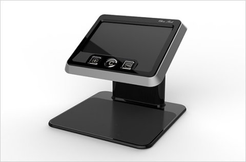 A black tablet-like device mounted to a black stand with a place for magnifying documents below the screen.