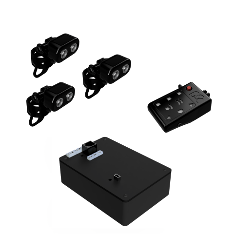 Small rectangular black power source with remote and controls along top adjacent to three Echo Heads with LED lights.