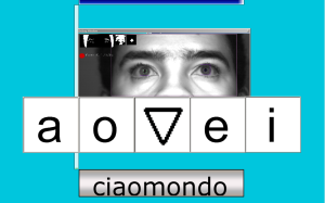 A screenshot of a user using CiaoMundo's 5-letter, eye-controlled keyboard with predictive type. The screen shows 5 symbols, "a," "o," a small triangle, and "i."