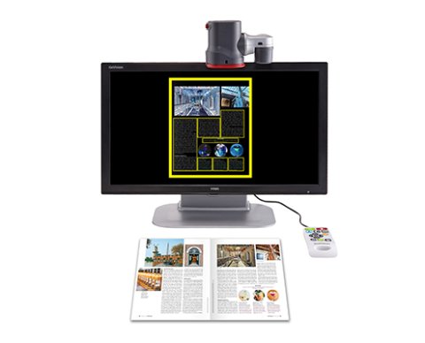 Video magnifier with camera mounted above monitor to read text below. The device is shown magnifying a magazine.