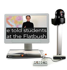 Video magnifier with words displayed on monitor screen. An external camera is connected to the right of the device, and the monitor is displaying a three-way split screen of different content.