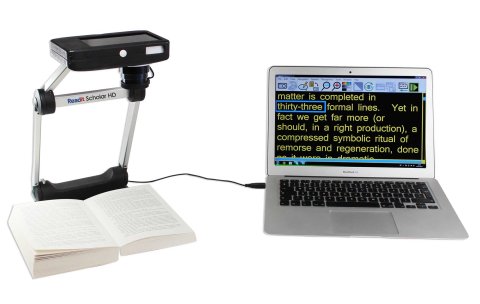Laptop connected to a stand magnifier, with an open book underneath at the magnifier's base.