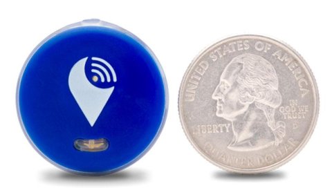 A round blue device with a small LED light on the bottom and sounds waves coming from a white dot in the center. Next to it is a quarter that is about the same size.