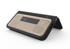 A small dark brown hinged device with speakers on the tan front and a small LCD display on the top.