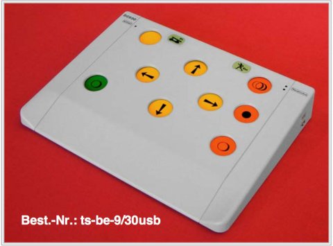 White rectangular control panel with 4 yellow buttons in the upper middle with arrow marks pointing right, left, top and bottom. There are 3 orange buttons on the right side and two buttons on the left, a yellow at the top edge and a green button parallel with the bottom orange button. 