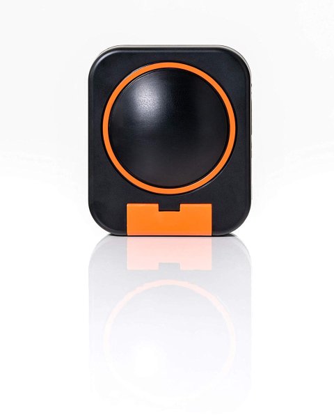 Rounded rectangular black device with circular bump in middle with an orange ring around it and an orange hinged compartment cover at bottom.