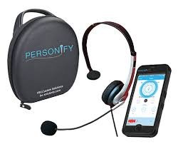 Black round case on left, with headset and microphone in the middle, and a smartphone on the right.