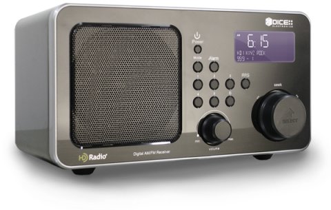A medium-sized dark grey device resembling an old-fashioned radio, with two round dials, various menu buttons, a built-in speaker, and a small LCD display panel on the front.