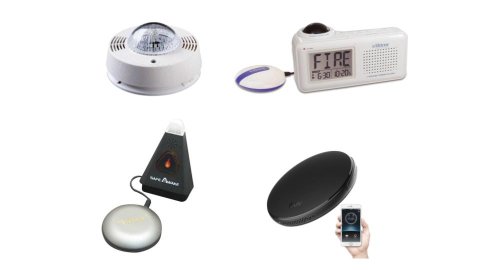 Various models of smoke/CO detector. One resembles a standard detector, but with an extra-large strobe light. Another resembles a digital alarm clock that says "Fire." Two others feature round bed shaker components—one of which is shown with a companion smartphone app.
