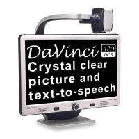 A silver desktop monitor displaying a black screen with high-contrast white font that reads "Da Vinci, crystal clear picture and text-to-speech." Above the monitor is a camera mounted on a gooseneck that is positioned over the monitor.