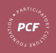 A red-brown background with the letters "PCF" in bold, white font in the center. Around the letters, forming a circle, are the words "Participatory Culture Foundation."