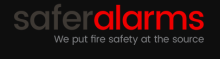 The company name is written without spaces "safer" in gray and "alarms" in red. The tag line below the name is written in white text print, "We put fire safety at the source".