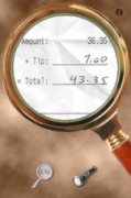 Screenshot of a magnifying glass graphic with a magnified photo showing a receipt in the center of the magnifying glass.