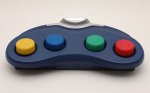 Long, blue half-moon shaped device with large yellow, blue, green, and red buttons.