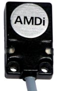 A black rectangular device with two mounting holes on the end and a cord on the bottom. 