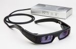 Black glasses with dark tinted lenses and a cord protruding from the end of the stem that leads to a small rectangular device with menu options on the side.
