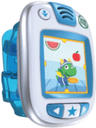 A wrist watch-like product with a big digital screen in the front along with control buttons below and speaker on top. The face of the device is white and the wrist band is blue. Shown on the screen is a colorful pic of a green frog in clothing and different red fruit.