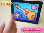 Front view of display screen that has a blue background, a yellow guitar, a starfish and seashell drawn on it.