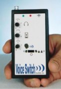 A rectangular black and white device that a user is holding in his hand. It features various input jacks and LED lights.