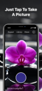 A flower on a mobile phone camera screen with a button to take a photo below. The caption reads "Just Tap To Take A Picture."